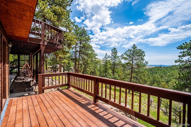 84 Sunny Ridge Ln, Bailey, CO 80421 - wooden terrace with a view of trees