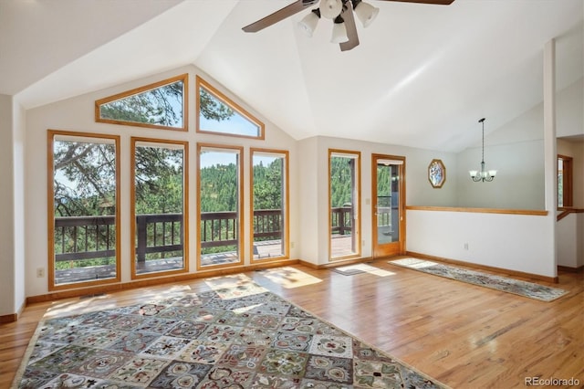 84 Sunny Ridge Ln, Bailey, CO 80421 - unfurnished living room featuring healthy amount of natural light, light wood-style floors, a chandelier, a ceiling fan, and high vaulted ceiling