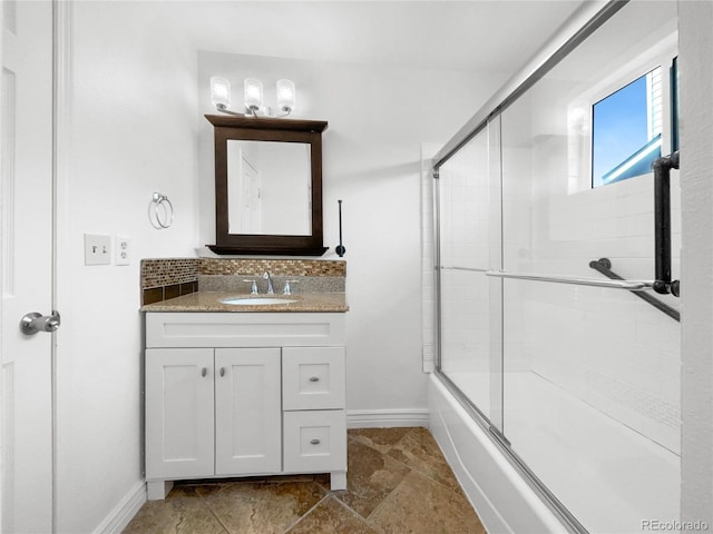 bathroom with shower / bath combination with glass door, backsplash, and vanity