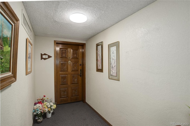 3675 S Cherokee St Unit 710, Englewood, CO 80110 - hall featuring dark colored carpet and a textured ceiling