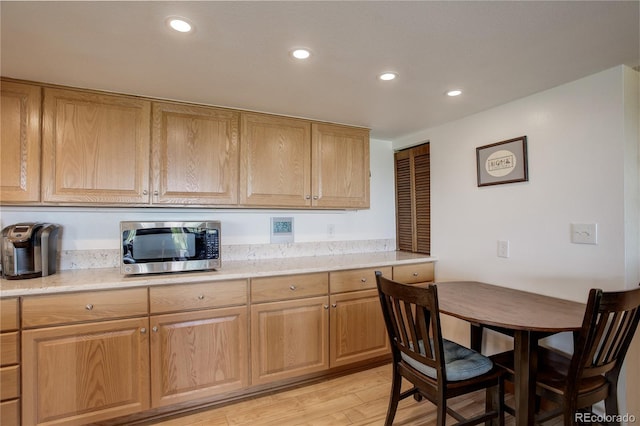 3675 S Cherokee St Unit 710, Englewood, CO 80110 - kitchen featuring stainless steel microwave, recessed lighting, and light wood-type flooring