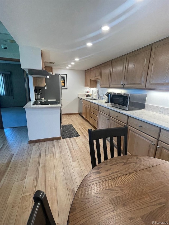 3675 S Cherokee St Unit 710, Englewood, CO 80110 - kitchen featuring appliances with stainless steel finishes, light wood finished floors, a sink, light countertops, and recessed lighting