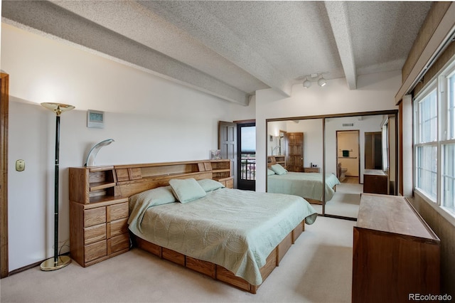 3675 S Cherokee St Unit 710, Englewood, CO 80110 - bedroom featuring a textured ceiling, light carpet, and a closet