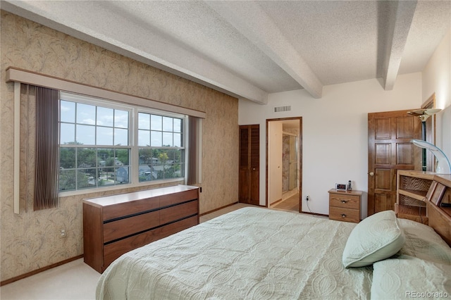 3675 S Cherokee St Unit 710, Englewood, CO 80110 - bedroom with beam ceiling, a textured ceiling, carpet flooring, baseboards, and wallpapered walls