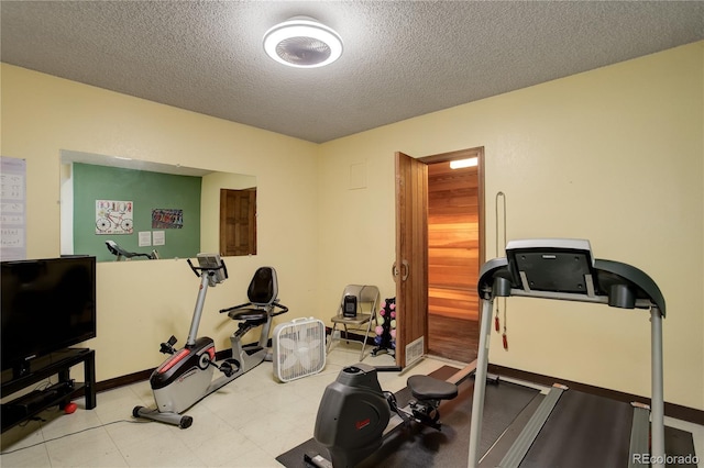 3675 S Cherokee St Unit 710, Englewood, CO 80110 - workout room with a textured ceiling and baseboards