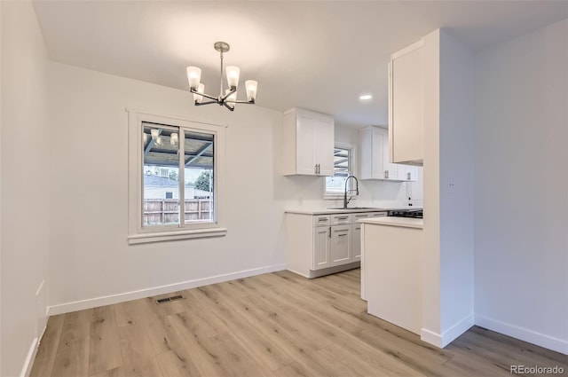 5090 Tejon St, Denver, CO 80221 - kitchen featuring a sink, a chandelier, light countertops, healthy amount of natural light, and recessed lighting
