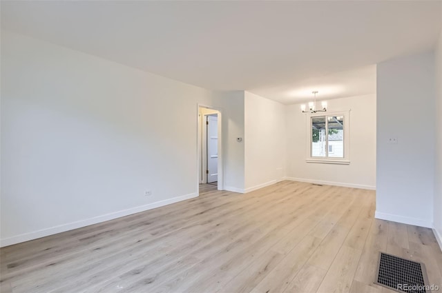 5090 Tejon St, Denver, CO 80221 - empty room with a chandelier, light wood finished floors, and baseboards