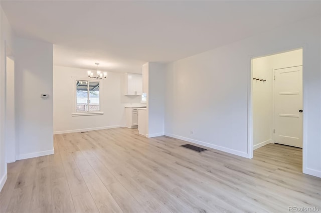 5090 Tejon St, Denver, CO 80221 - unfurnished living room featuring a chandelier, light wood finished floors, and baseboards