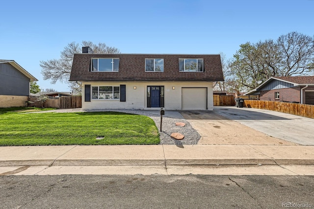 view of front property featuring fence, a shingled roof, a front yard, mansard roof, and driveway
