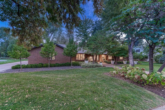 view of front of house featuring a front yard and brick siding