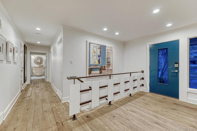 corridor featuring baseboards, ornamental molding, light wood-style flooring, and recessed lighting