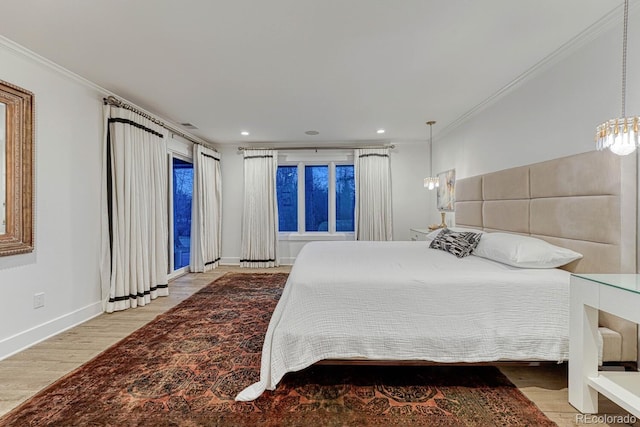 bedroom with recessed lighting, crown molding, baseboards, and wood finished floors