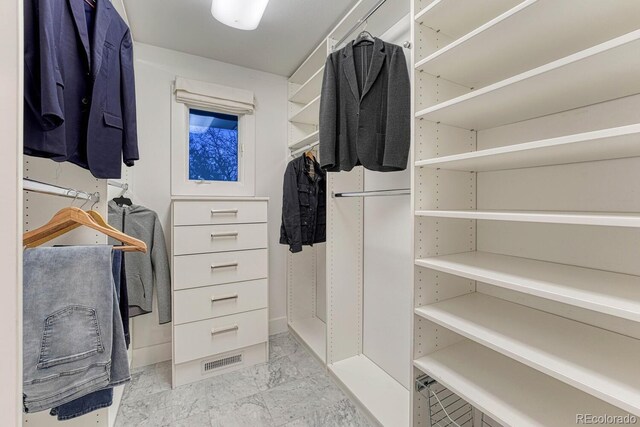 spacious closet featuring marble finish floor