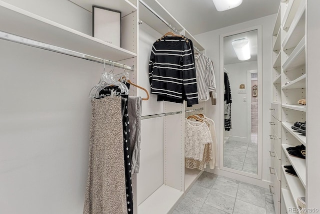 spacious closet featuring light tile patterned floors