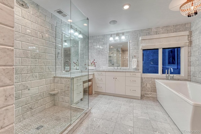 full bath with a shower stall, visible vents, tile walls, and vanity