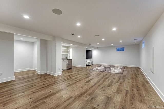 unfurnished living room featuring baseboards, wood finished floors, and recessed lighting