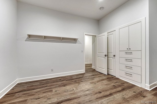 unfurnished bedroom with baseboards and wood finished floors