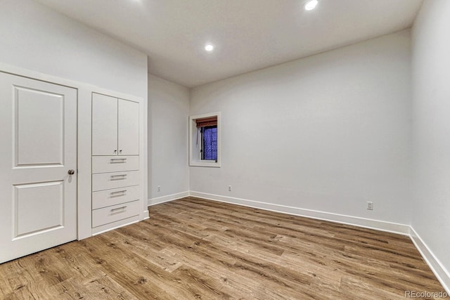 unfurnished bedroom with recessed lighting, baseboards, and light wood finished floors