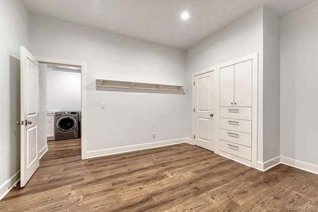 clothes washing area with washer / dryer, laundry area, baseboards, wood finished floors, and recessed lighting