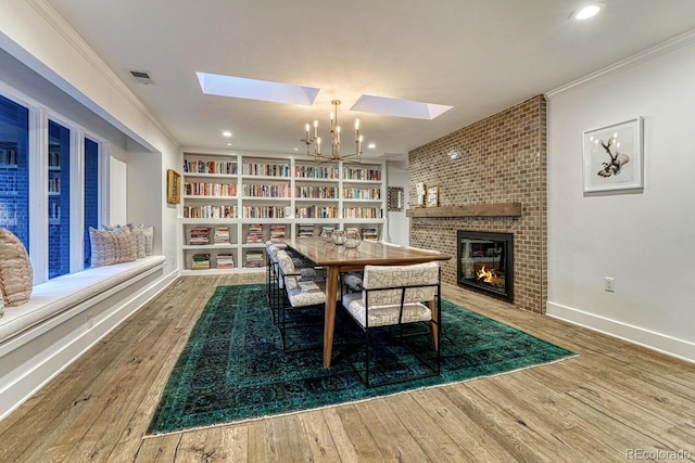 dining room featuring hardwood / wood-style floors, visible vents, and crown molding