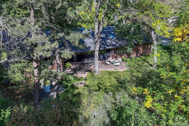 birds eye view of property with a forest view