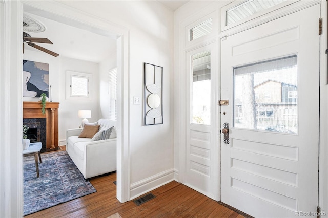2826 Quitman St, Denver, CO 80212 - foyer entrance with dark wood-style flooring, a fireplace, and ceiling fan