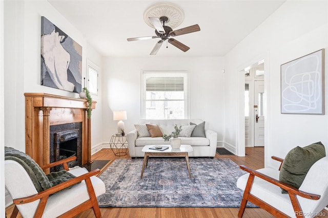 2826 Quitman St, Denver, CO 80212 - living area with a ceiling fan, a fireplace with flush hearth, and wood finished floors