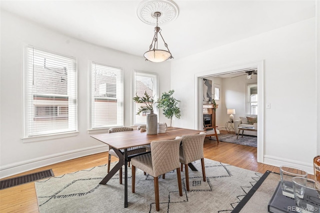 2826 Quitman St, Denver, CO 80212 - dining space with a glass covered fireplace and light wood-style flooring