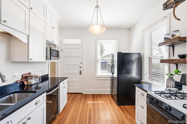 2826 Quitman St, Denver, CO 80212 - kitchen featuring freestanding refrigerator, open shelves, dishwashing machine, white gas range oven, and stainless steel microwave