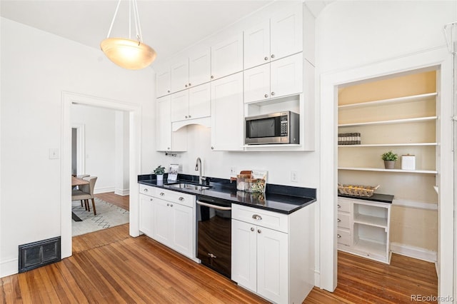 2826 Quitman St, Denver, CO 80212 - kitchen featuring dishwasher, stainless steel microwave, wood finished floors, and white cabinets