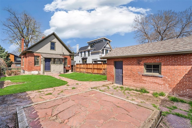 2826 Quitman St, Denver, CO 80212 - back of house featuring brick siding, a patio area, and roof with shingles