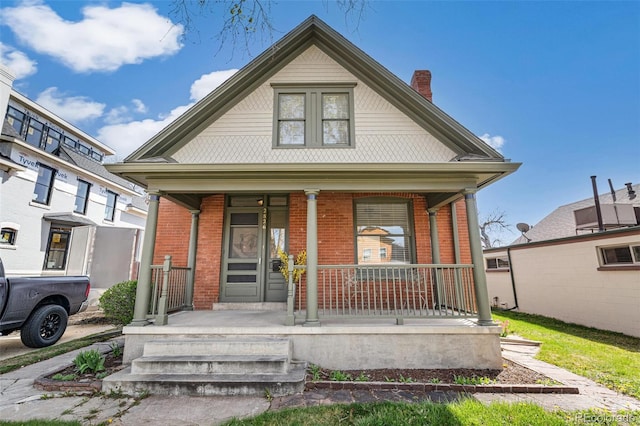 2826 Quitman St, Denver, CO 80212 - bungalow-style house with a porch, brick siding, and a chimney