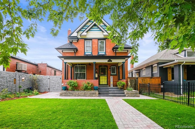 3811 N Clay St, Denver, CO 80211 - victorian-style house with a gate, a front lawn, brick siding, and fence private yard