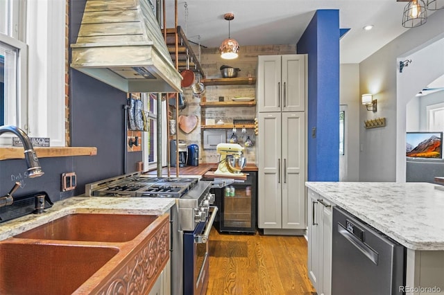 3811 N Clay St, Denver, CO 80211 - kitchen with open shelves, light stone countertops, appliances with stainless steel finishes, hanging light fixtures, and light wood-style floors