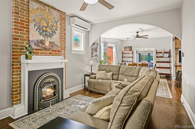 3811 N Clay St, Denver, CO 80211 - living room featuring arched walkways, ceiling fan, a wall unit AC, and dark wood finished floors