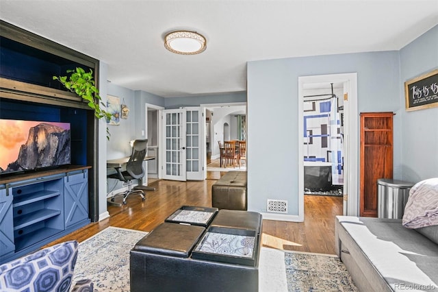 3811 N Clay St, Denver, CO 80211 - living area with french doors, arched walkways, and wood finished floors