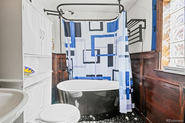 3811 N Clay St, Denver, CO 80211 - bathroom featuring a freestanding tub, toilet, and a sink