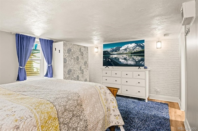 3811 N Clay St, Denver, CO 80211 - bedroom with wood finished floors, brick wall, and a textured ceiling