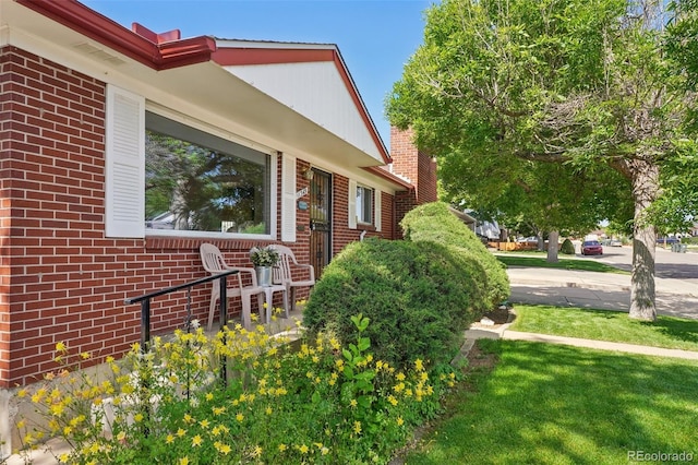 11349 Downing Dr, Northglenn, CO 80233 - view of side of home with brick siding and a yard