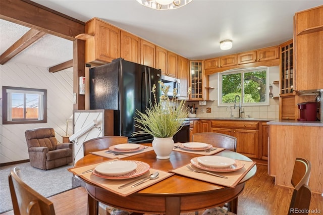 11349 Downing Dr, Northglenn, CO 80233 - kitchen featuring stainless steel microwave, freestanding refrigerator, decorative backsplash, beam ceiling, and light wood-style flooring