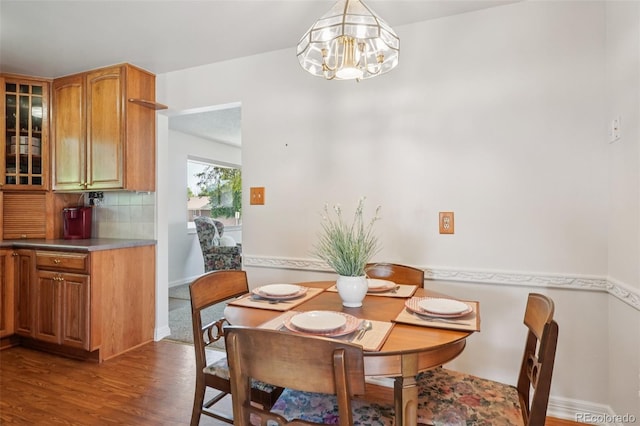11349 Downing Dr, Northglenn, CO 80233 - dining area featuring a chandelier and dark wood-style floors
