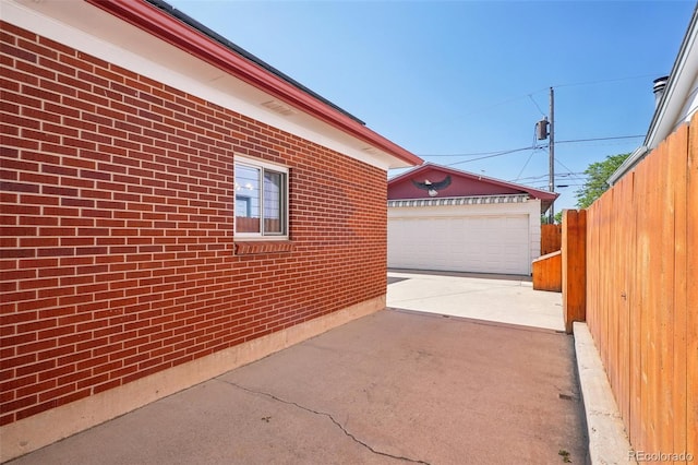 11349 Downing Dr, Northglenn, CO 80233 - view of patio featuring an outdoor structure and a detached garage