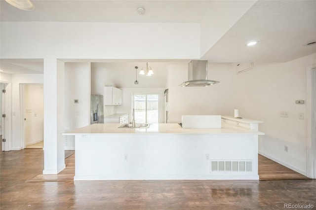 7010 W 44th Ave, Wheat Ridge, CO 80033 - kitchen featuring stainless steel refrigerator with ice dispenser, white cabinetry, wood finished floors, light countertops, and recessed lighting