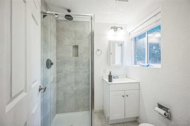 7010 W 44th Ave, Wheat Ridge, CO 80033 - full bath with a shower stall, vanity, a textured ceiling, and a textured wall
