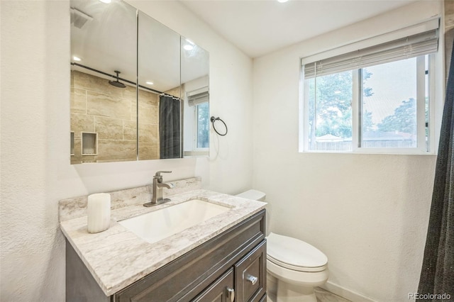 7010 W 44th Ave, Wheat Ridge, CO 80033 - bathroom with plenty of natural light, vanity, curtained shower, a textured wall, and recessed lighting