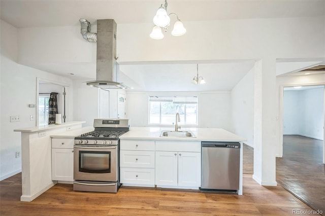 7010 W 44th Ave, Wheat Ridge, CO 80033 - kitchen with appliances with stainless steel finishes, ventilation hood, a chandelier, white cabinetry, and light countertops