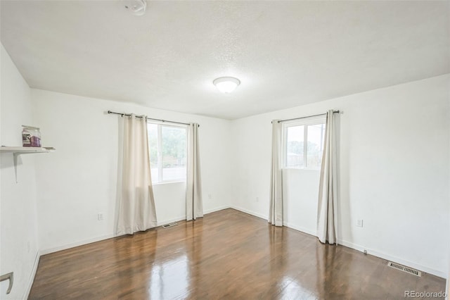7010 W 44th Ave, Wheat Ridge, CO 80033 - spare room with wood finished floors, a smoke detector, and a textured ceiling