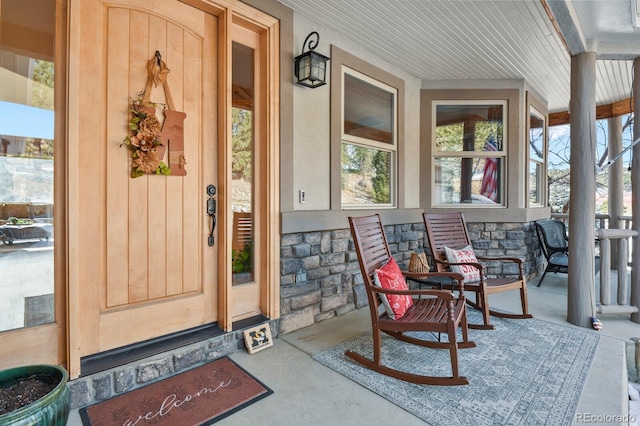 doorway to property featuring covered porch