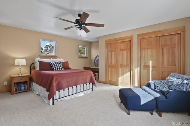 bedroom with ceiling fan and light carpet