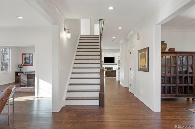 staircase featuring hardwood / wood-style floors and crown molding